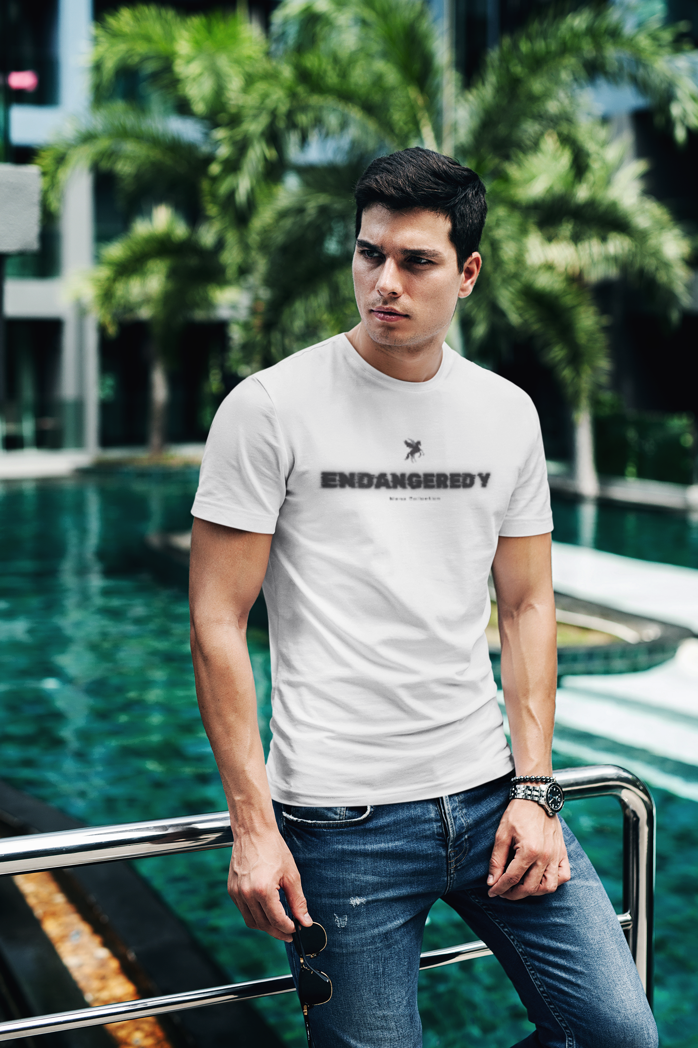 t shirt mockup of a fashionable man posing by a pool 430 el